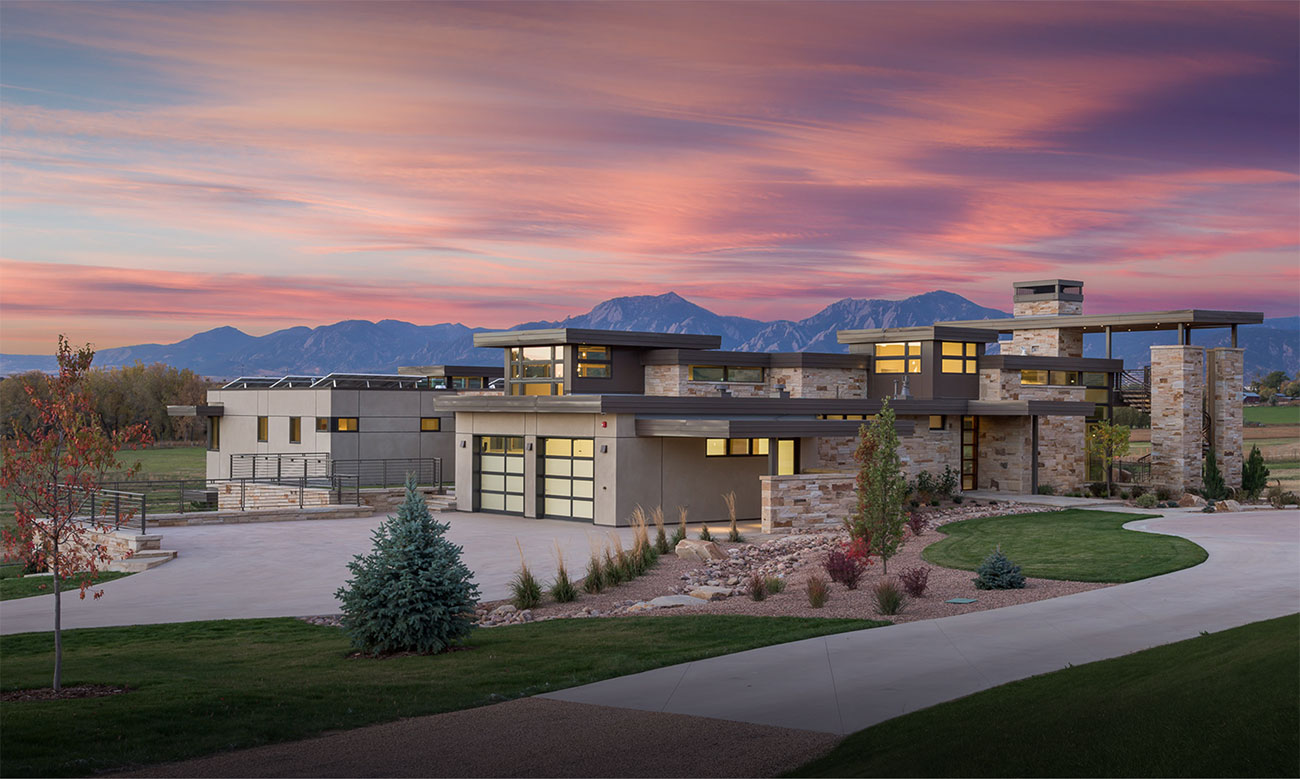 Modern Boulder County home at sunset with native landscape